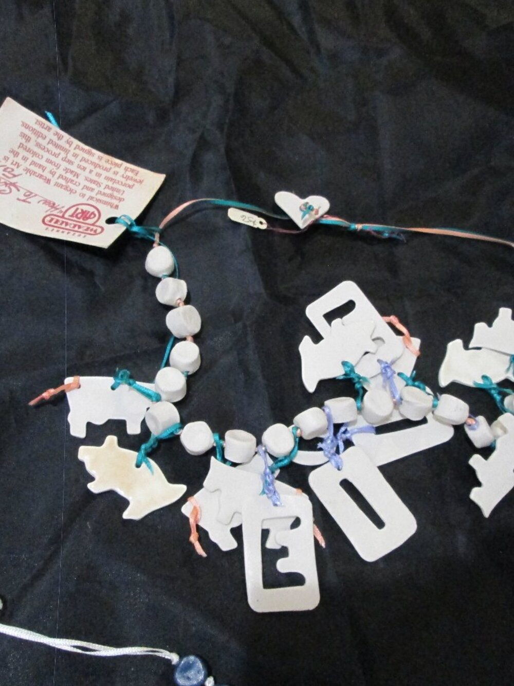 Cows and E,I,O lettering old timey nostalgic artistic necklace